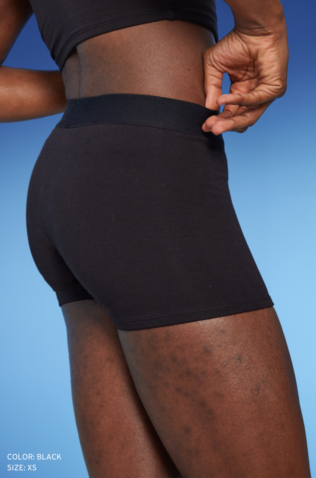 Model is wearing the Cotton Compression Boy Short in Black, size XS